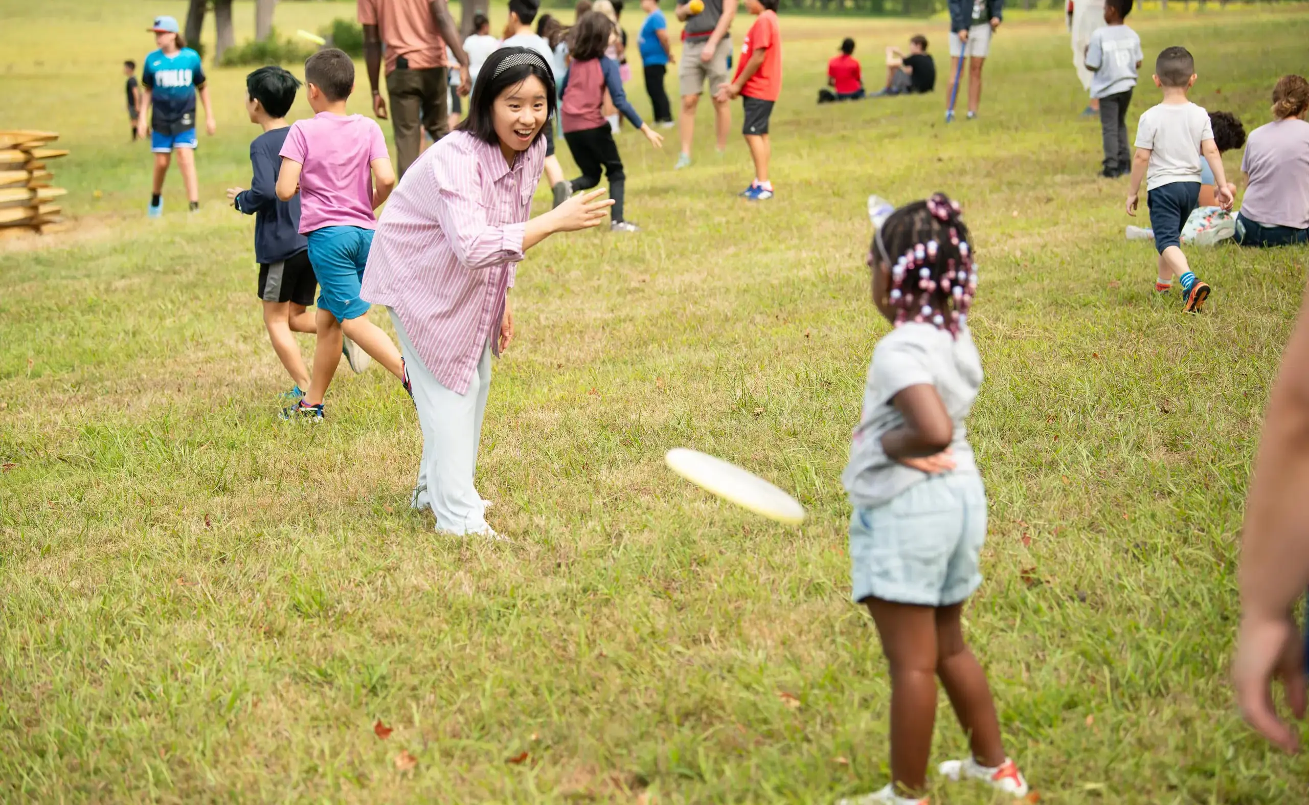 Teacher playing frisbee with student