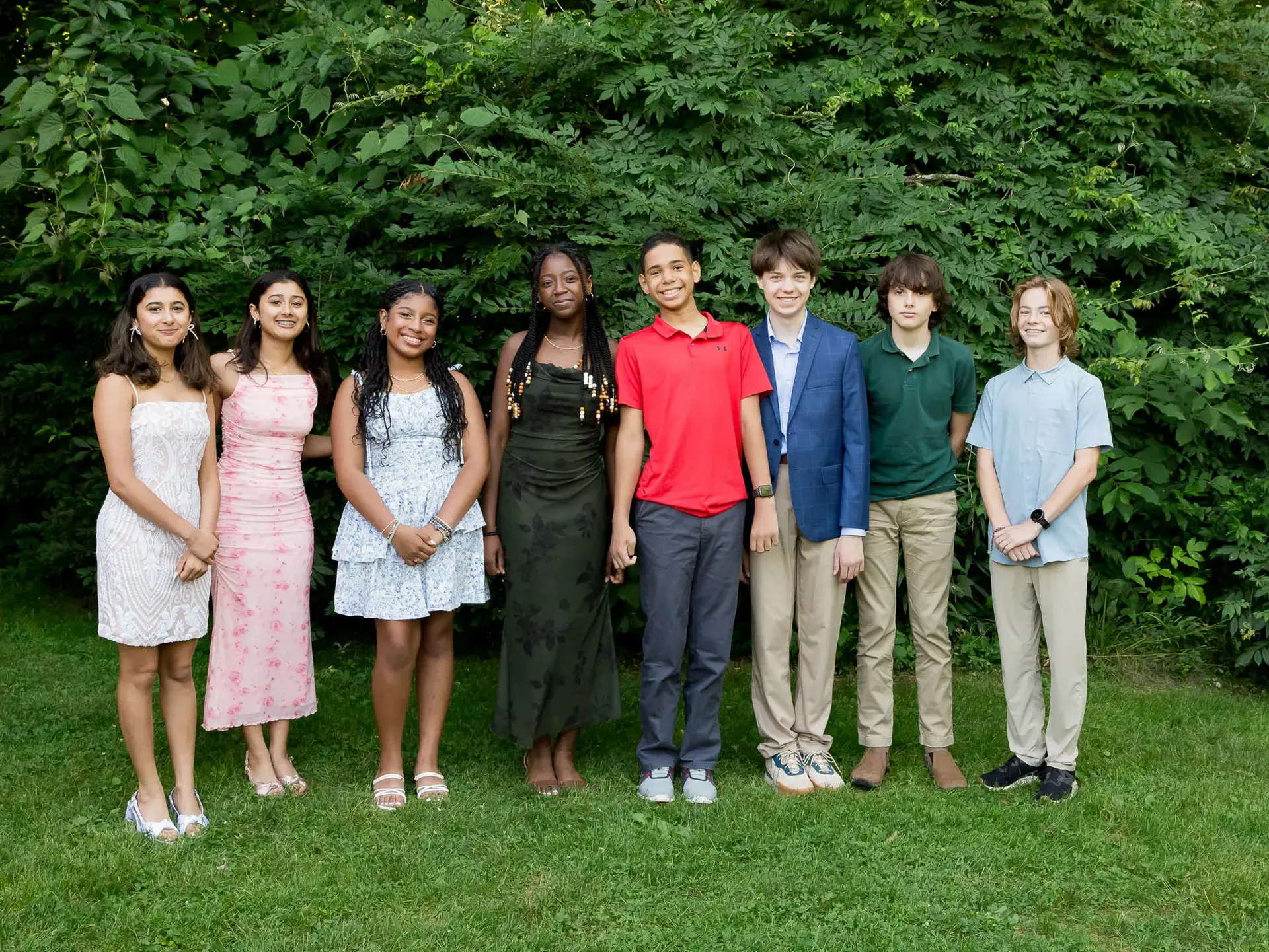 Group of students posing together on grass
