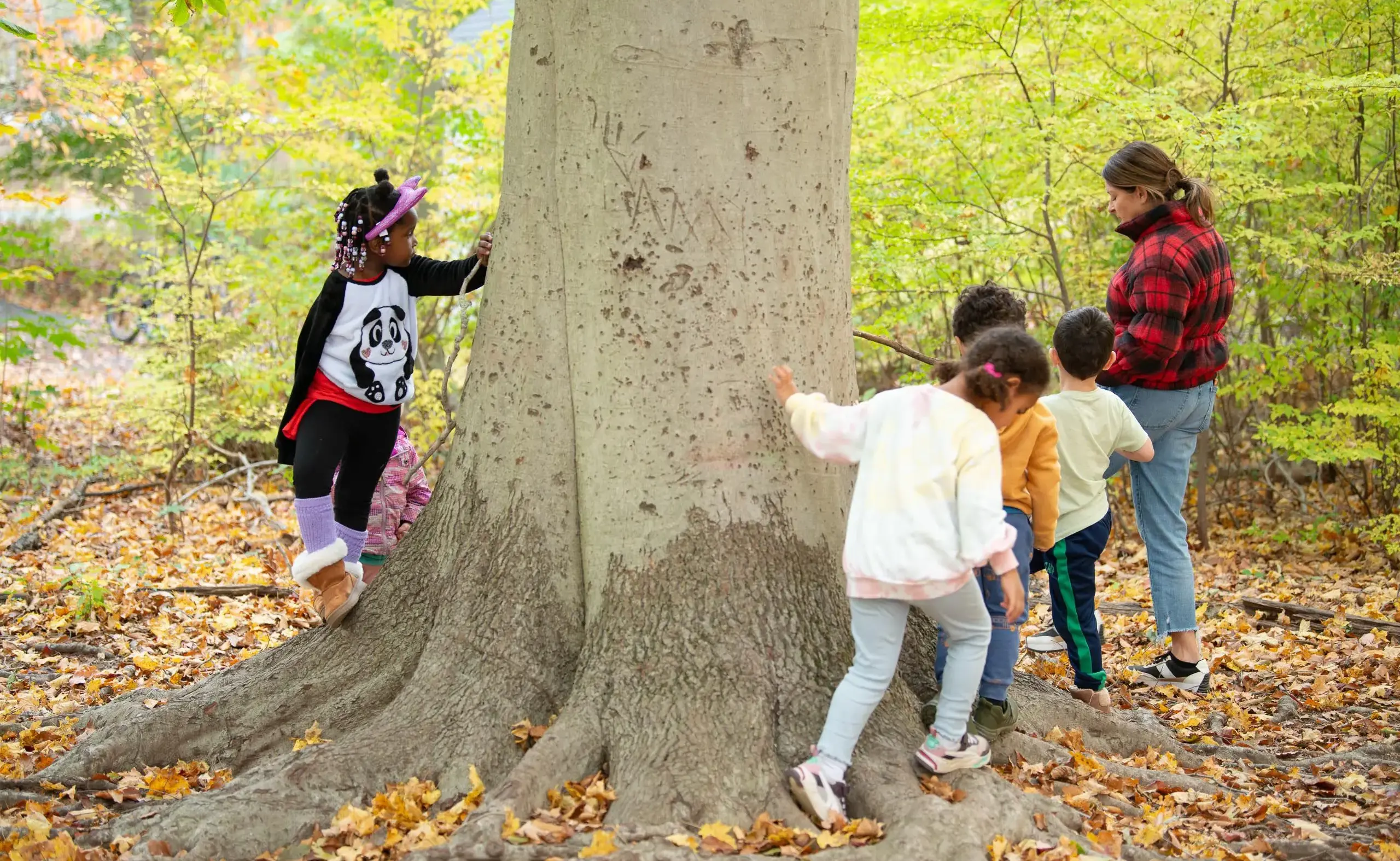 Kids running around tree