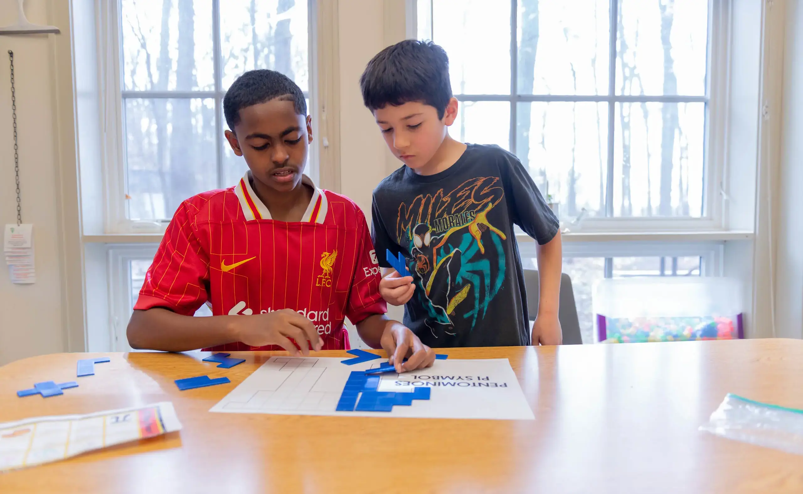 Two students participating in activity at desk