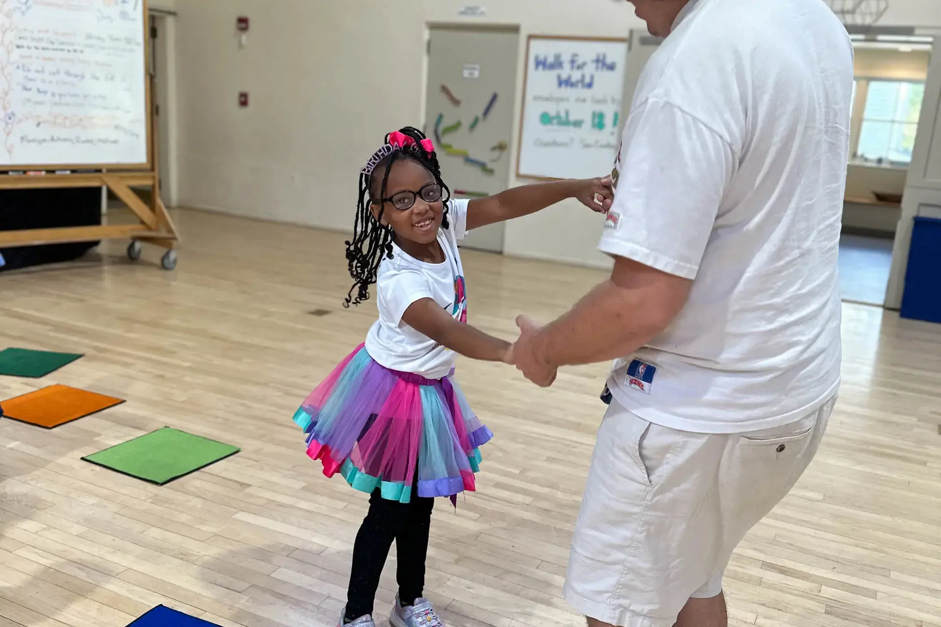 Student dancing, wearing colorful tutu