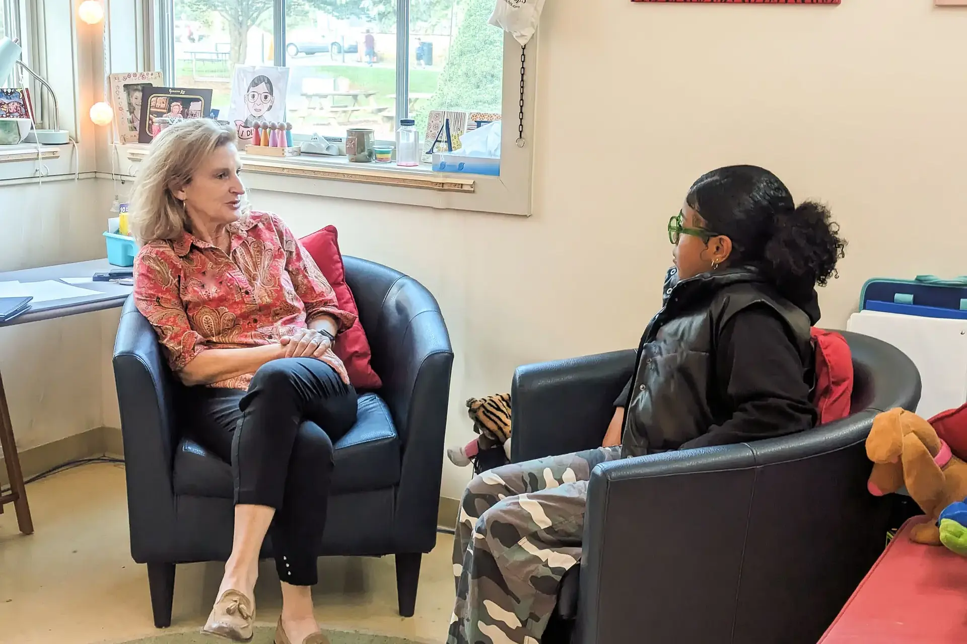 Student and teacher chatting in armchairs