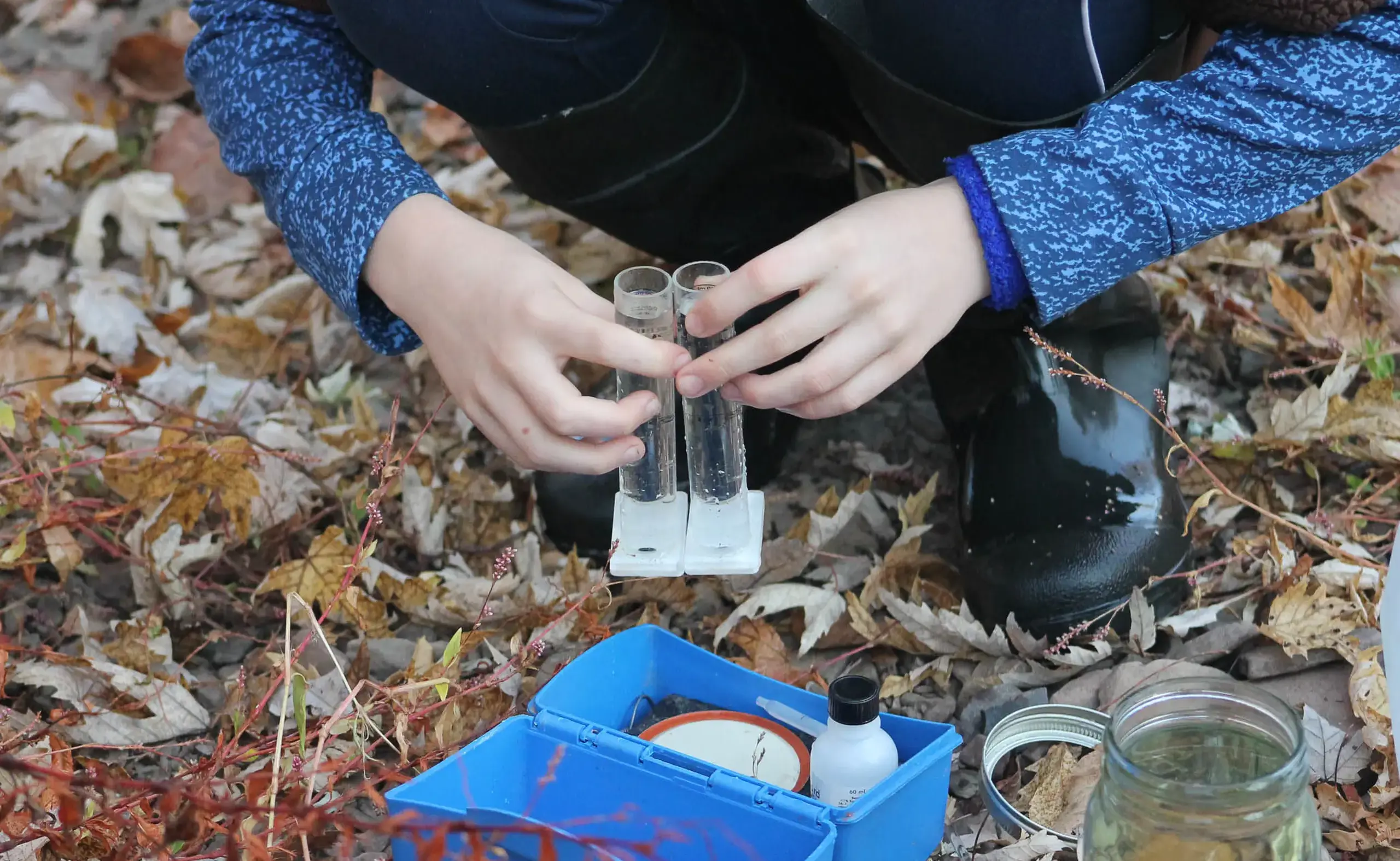 Someone removing sample vials from a small box