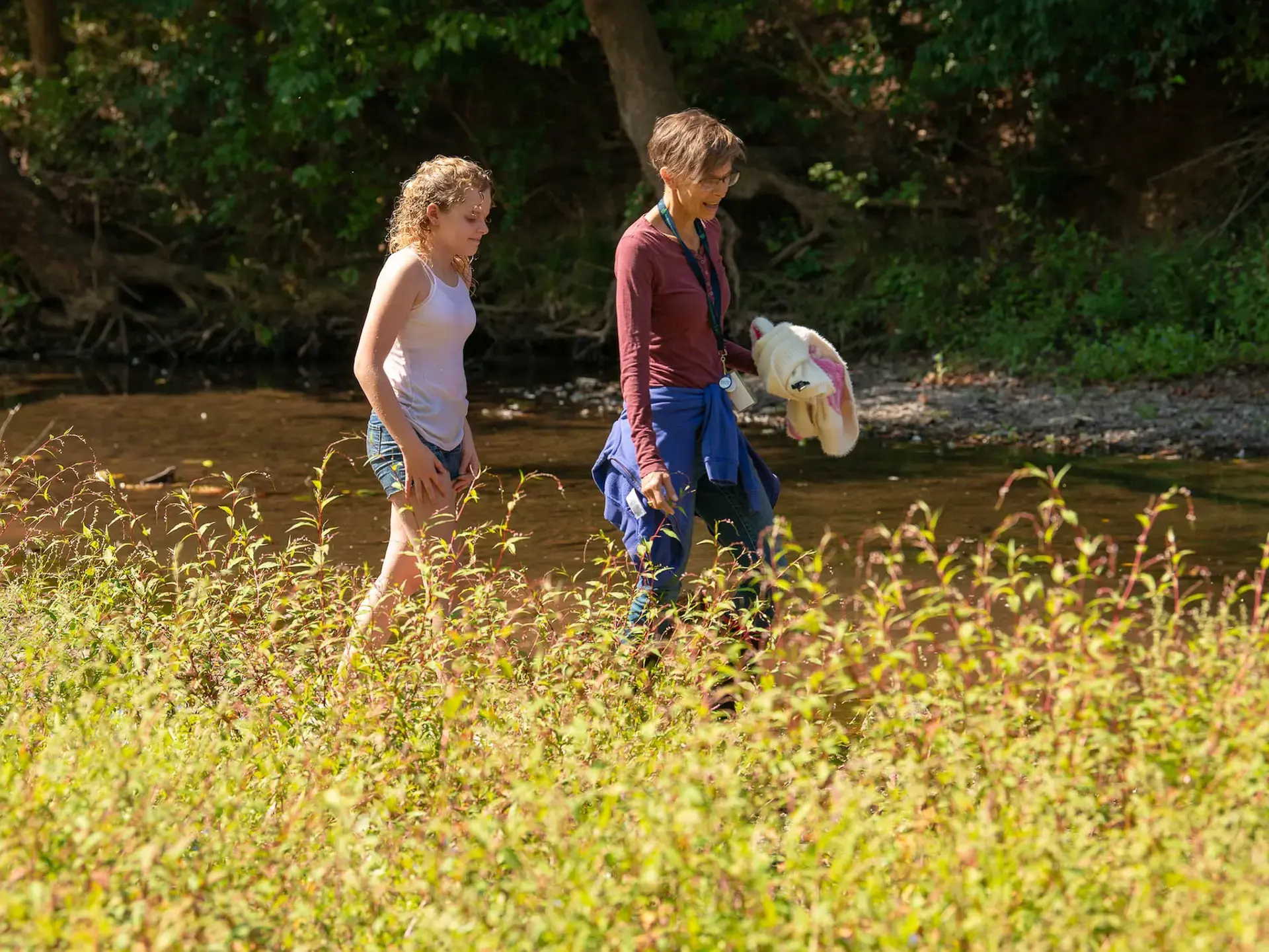 Students walking by stream