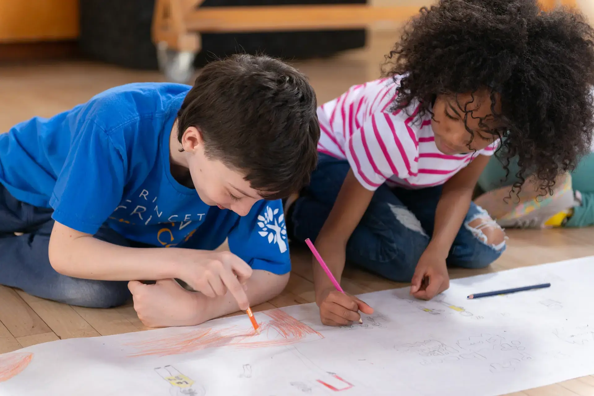 Students drawing together on floor