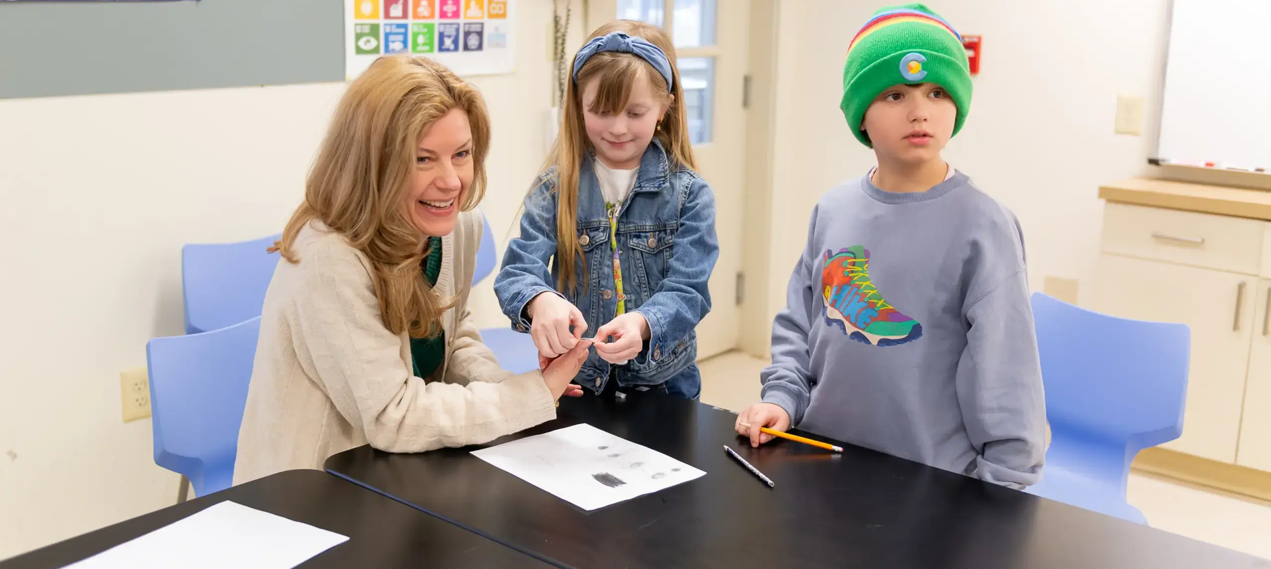 Teacher laughing with two students