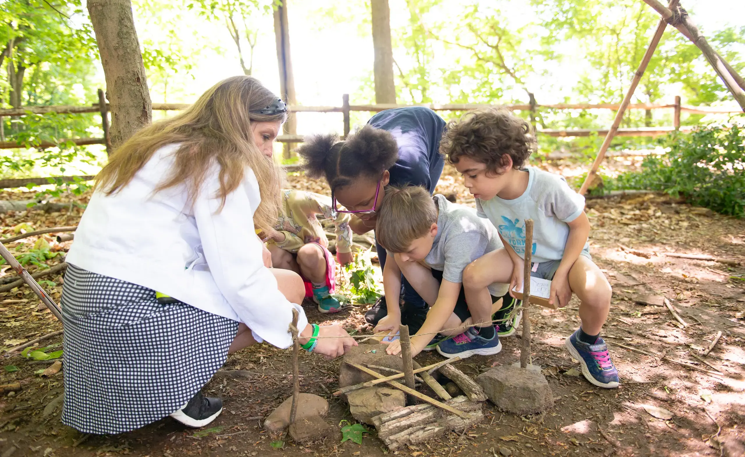 Student and teacher making a fire